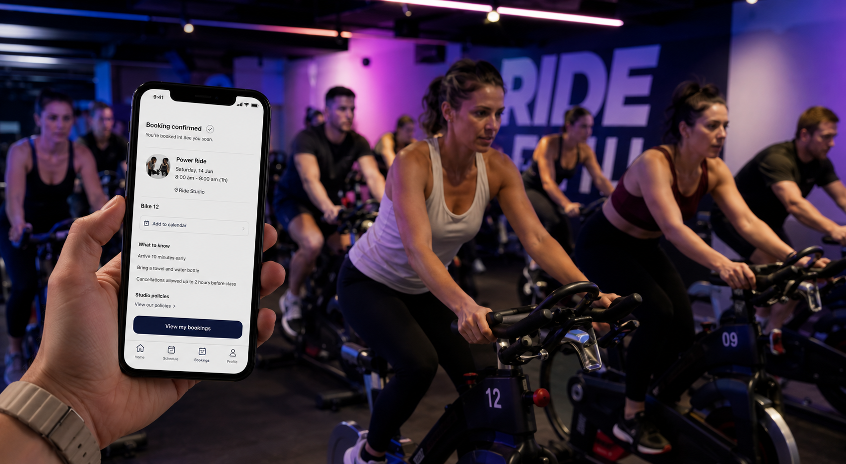 Indoor cycling spin class with CoreBookings booking on phone