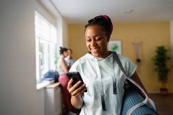 Student using mobile phone in yoga class